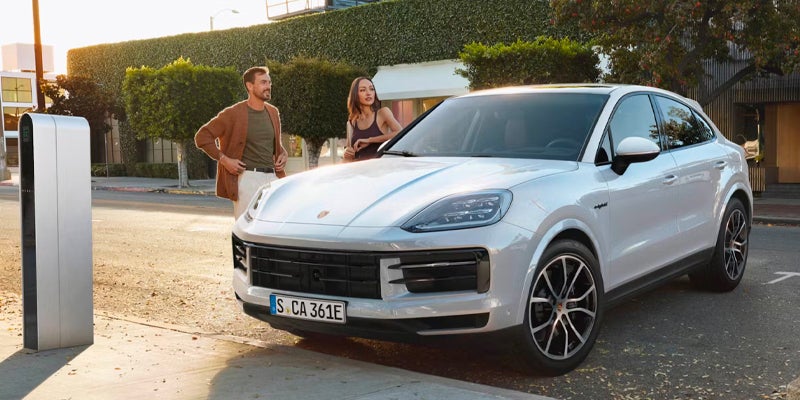 Couple standing next to Cayenne Coupe